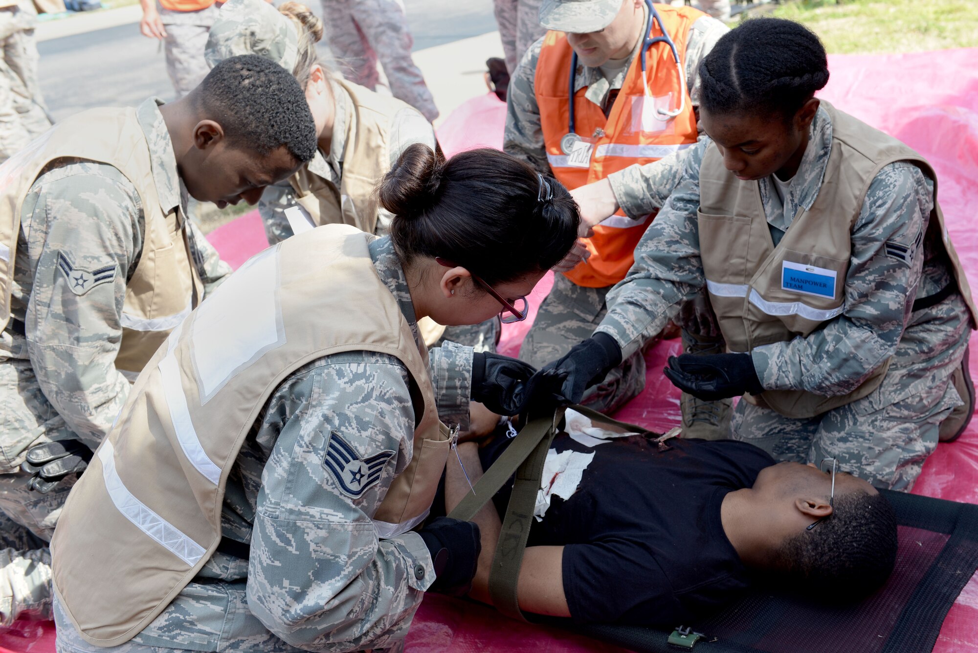 U.S.  Airmen assigned to the 633rd Medical Group prepare a casualty for transport during a mass casualty exercise at Langley Air Force Base, Va., March 24, 2016. Approximately 600 medical personnel participated in the exercise in preparation for the AirPower over Hampton Roads Open House, April 22-24th.(U.S. Air Force photo by Airman 1st Class Kaylee Dubois)