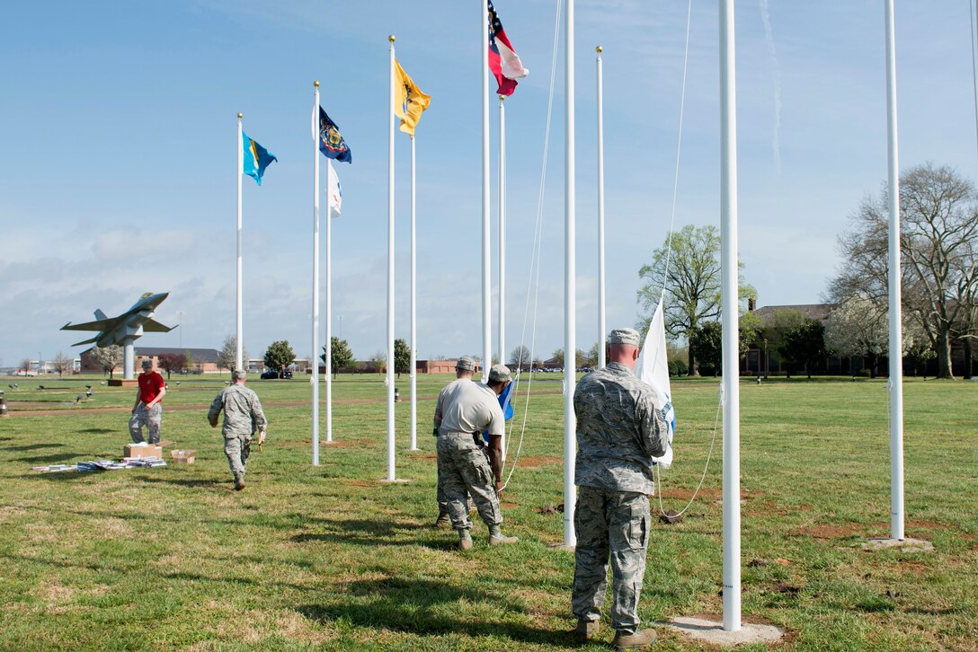 U.S. Airmen assigned to the 633rd Civil Engineer Squadron raise state flags at Memorial Park at Langley Air Force Base, Va., March 25, 2016. The park was developed in 1983 on the Tactical Air Command Parade Grounds by order of Gen. Bill Creech, then-TAC commander, to memorialize Service members who lost their lives in conflicts around the world. (U.S. Air Force photo by Airman 1st Class Derek Seifert)