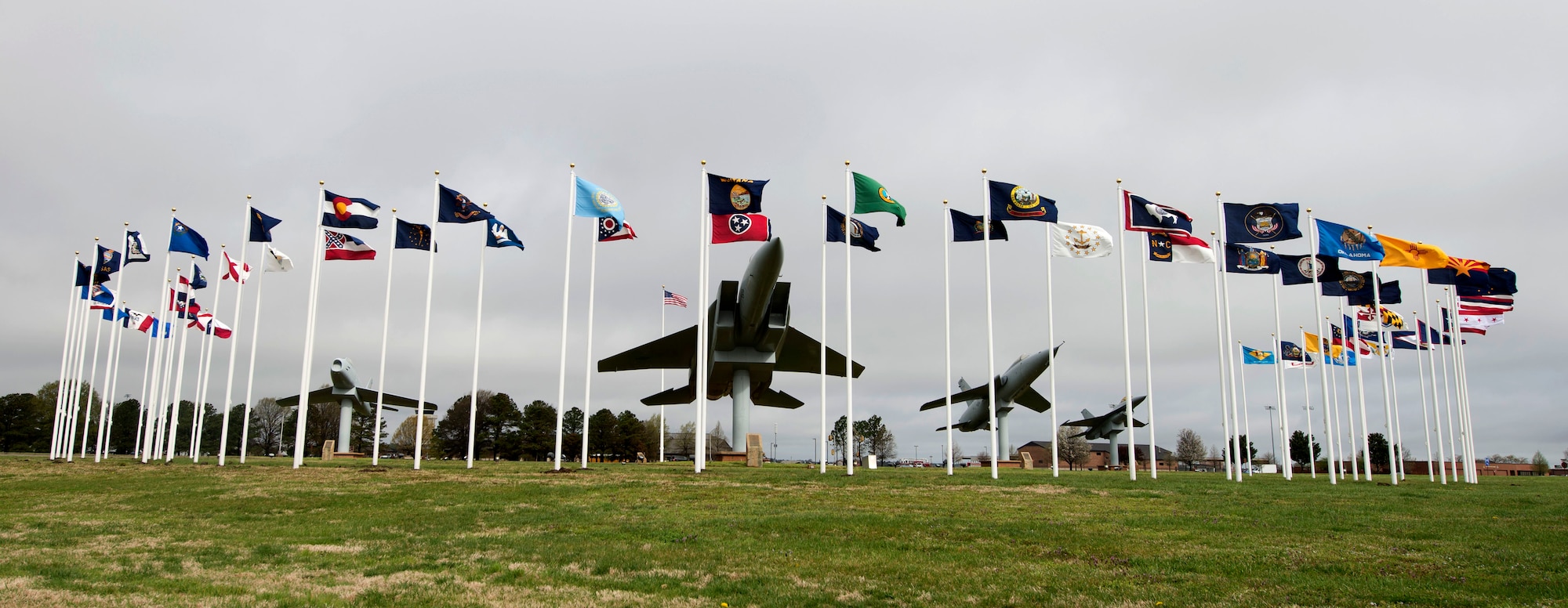 The 50 U.S. state flags, six U.S. territories’, Air Force and Army flags wave at Memorial Park at Langley Air Force Base, Va., March 28, 2016. Along with the flags, F-86 Sabre, F-105 Thunderchief, F-15A Eagle and F-16 Fighting Falcon replicas memorialize Service members who gave their lives in past conflicts, such as the Korean, Vietnam and Cold Wars. (U.S. Air Force photo by Airman 1st Class Derek Seifert)