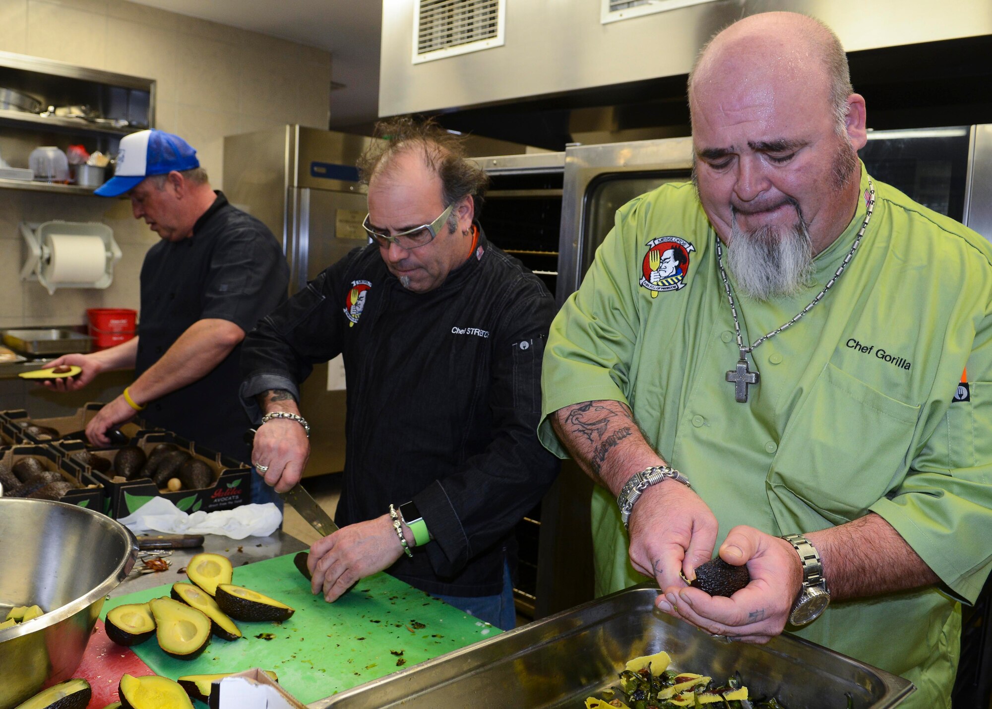 From left, chefs Sikey, Stretch and Gorilla Rich, three “Messlords” members, prepare avocados for a Mexican-themed lunch, March 25, 2016, at Aviano Air Base, Italy. The Messlords tour around the globe preparing food for Service members and sharing their recipes. (U.S. Air Force photo by Senior Airman Austin Harvill/Released)