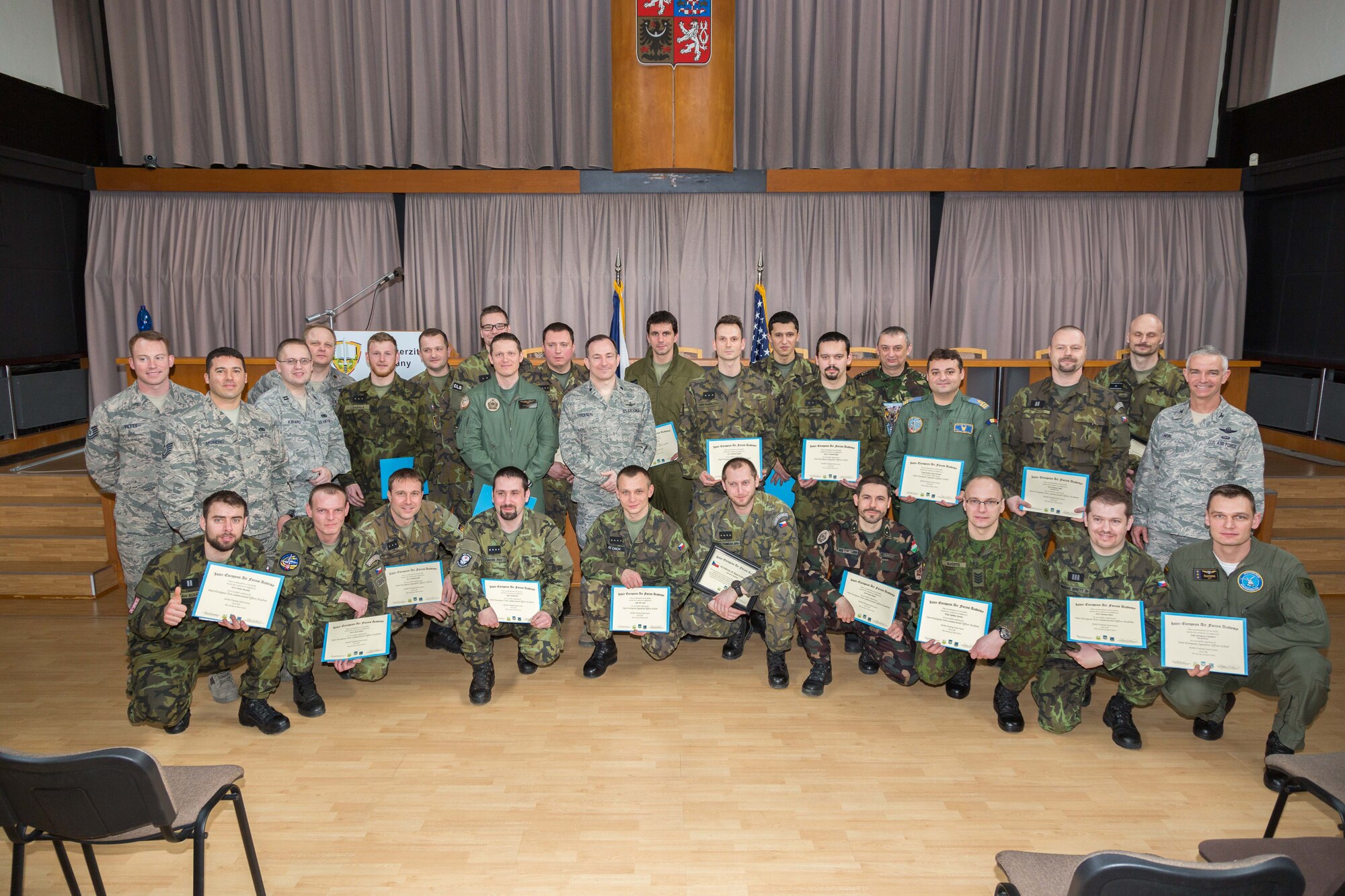 Students and Inter-European Air Forces Academy staff pose for a photo after graduation during a combined international officer and NCO mobile professional military education course in Brno, Czech Republic, March 4, 2016. Twenty-one students from Czech Republic, Hungary, Lithuania and Romania participated in the course. This was the IEAFA’s second two-week course. IEAFA’s first five-week in-residence course begins April 25, 2016 at Kapaun Air Station, Germany. (U.S. Air Force photo/Senior Master Sgt. Travis Robbins)