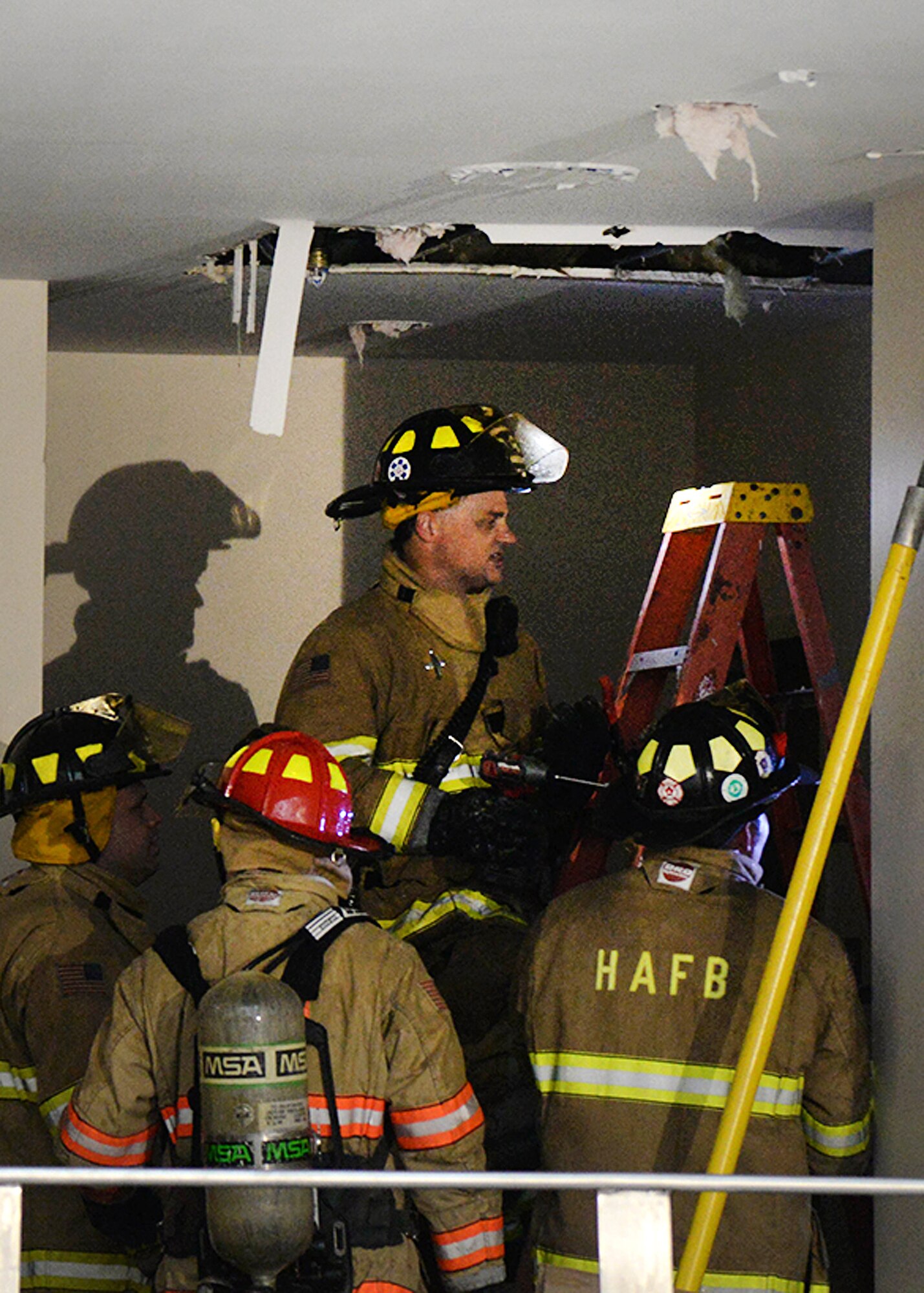 Firefighters from the base and nearby communities inspect an area inside the new middle school at Hanscom Air Force Base, Mass., March 28 after successfully extinguishing a fire. The school is currently unoccupied, except by construction workers. (U.S. Air Force photo by Linda LaBonte Britt)