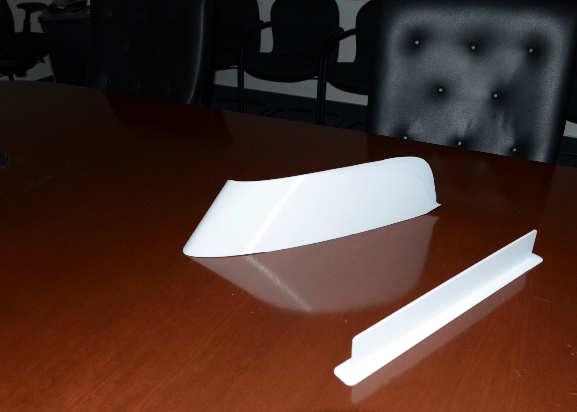 In the third phase of C-17 Drag Reduction testing, the Finlets will be removed and microvanes will be placed on each side of the aft fuselage. The fourth phase will see fairings attached to locations on the wings near the engines and winglets. Pictured above is a fairing (top) and a microvane. These are produced by Lockheed Martin with a 3-D printer. (U.S. Air Force photo by Kenji Thuloweit)

