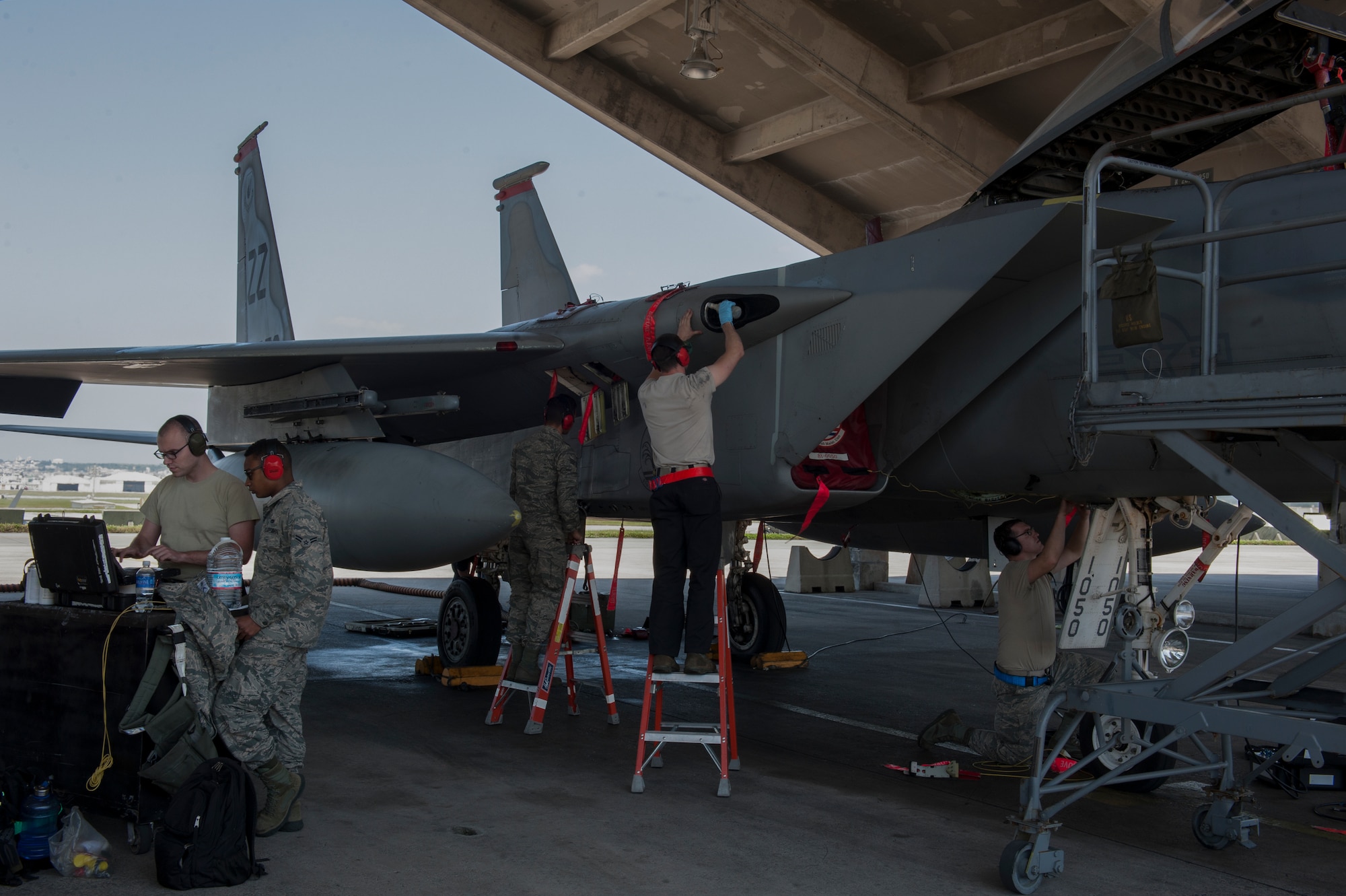 Airmen with the 18th Aircraft Maintenance Squadron perform maintenance on an F-15 Eagle March 29, 2016, at Kadena Air Base, Japan.  Before and during their work, Airmen must reference technical orders to perform proper maintenance on the aircraft. (U.S. Air Force photo by Airman 1st Class Lynette M. Rolen)