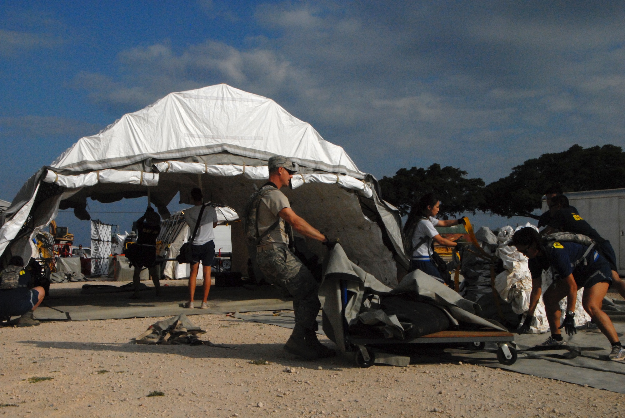 Airmen from the Hawaii Air National Guard's Detachment 1, Headquarters 154th Medical set up a tent to be used as the injury treatment section during a Collective Training Exercise at Kalaeloa, Hawaii, Mar. 23, 2016. This was the first CTE since the unit was stood up in Nov. 2015. The exercise was designed to test the Hawaii National Guard’s Chemical, Biological, Radiological, Nuclear and Explosive Enhanced Response Force Package. (U.S. Air National Guard photo by Senior Airman Orlando Corpuz/released)