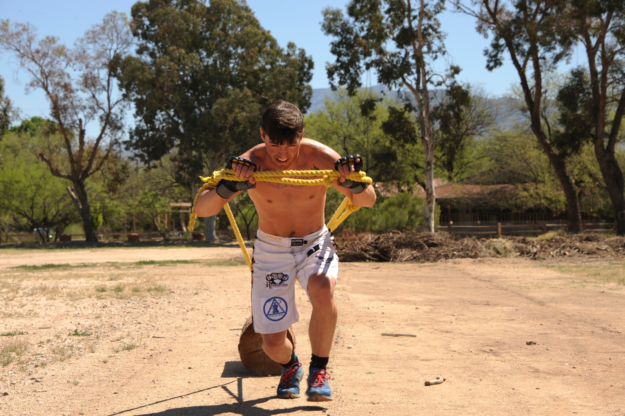 U.S. Air Force Senior Airman Jeremiah Garber, 355th Maintenance Group analyst, drags a log during training at the Amity Circle Tree Ranch in Tucson, Ariz., March 26, 2016. Garber performed exercises that would strengthen muscles needed in a mixed martial arts match. (U.S. Air Force photo by Airman Nathan H. Barbour/Released)