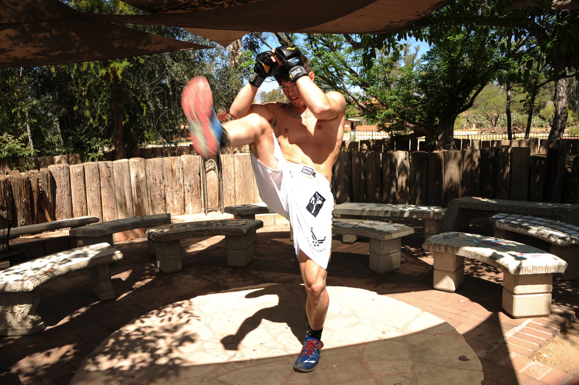 U.S. Air Force Senior Airman Jeremiah Garber, 355th Maintenance Group analyst, performs a high kick during training at the Amity Circle Tree Ranch in Tucson, Ariz., March 26, 2016. Garber practiced his technique while imagining an opponent in front of him. (U.S. Air Force photo by Airman Nathan H. Barbour/Released)