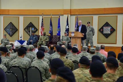 Mr. David G. Brown, Strategic Command Consultation (SCC) Committee member (standing, second from right), provides remarks during an award ceremony honoring the 341st Missile Wing at Malmstrom Air Force Base, Mont., March 30, 2016. During the ceremony, Brown and U.S. Navy Adm. Cecil D. Haney, U.S. Strategic Command (USSTRATCOM) commander (seated left), presented the 2015 Omaha Trophy, ICBM category, to U.S. Air Force Col. John T. Wilcox II, 341st Missile Wing commander (seated right) and Team Malmstrom, in recognition of the wing's contributions to USSTRATCOM's global strategic missions. The Omaha Trophy, which dates back to the U.S. Air Force's Strategic Air Command, was originally created by the SCC in 1971. At the time, a single trophy was presented annually as a token of appreciation to USSTRATCOM's best wing. Since then, the tradition has evolved to unit-level awards that recognize the command's premier intercontinental ballistic missile (ICBM) wing, ballistic missile submarine, strategic bomber wing and global operations (space/cyberspace) unit. This year, a new category was added to include the combatant command's top strategic aircraft wing. (U.S. Air Force photo by Airman Daniel Brosam) Story Available: https://www.stratcom.mil/news/2016/595/-/