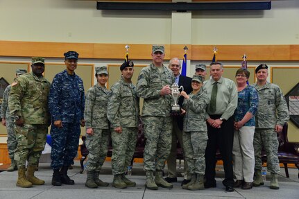 U.S. Navy Adm. Cecil D. Haney, U.S. Strategic Command (USSTRATCOM) commander (second from left); U.S. Army Command Sgt. Maj. Patrick Z. Alston, USSTRATCOM senior enlisted leader (left); and Mr. David G. Brown, Strategic Command Consultation (SCC) Committee member (center right), pose for a photo with Airmen and civilians after an award ceremony honoring the 341st Missile Wing at Malmstrom Air Force Base, Mont., March 30, 2016. During the ceremony, Haney and Brown presented the 2015 Omaha Trophy, ICBM category, to U.S. Air Force Col. John T. Wilcox II, 341st Missile Wing commander (not pictured) and Team Malmstrom, in recognition of the wing's contributions to USSTRATCOM's global strategic missions. The Omaha Trophy, which was originally created by the SCC in 1971, was presented to the wing in recognition of their contributions to USSTRATCOM's global strategic missions. At the time, a single trophy was presented annually as a token of appreciation to USSTRATCOM's best wing. Since then, the tradition has evolved to unit-level awards that recognize the command's premier ICBM wing, ballistic missile submarine, strategic bomber wing and global operations (space/cyberspace) unit. This year, a new category was added to include the combatant command's top strategic aircraft wing. (U.S. Air Force photo by Airman Daniel Brosam)Story Available: https://www.stratcom.mil/news/2016/595/-/
