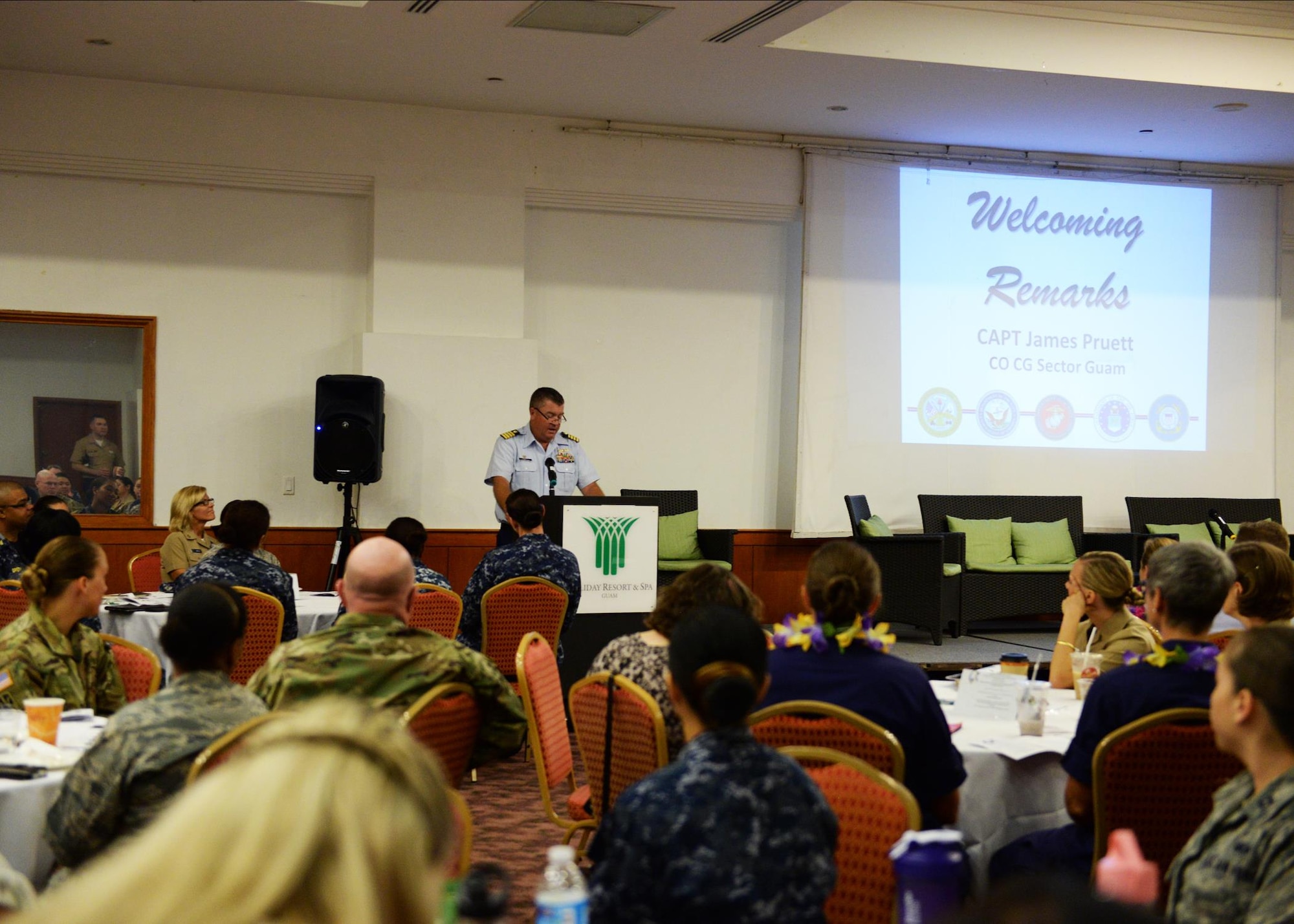 U.S. Coast Guard Capt. James Pruett, Coast Guard sector commander, gives the opening speech during the Joint Women’s Leadership Symposium March 24, 2016, in Tumon, Guam. The symposium gave both military and civilian attendees the chance to network and meet individuals with common goals. (U.S. Air Force photo by Senior Airman Cierra Presentado)   