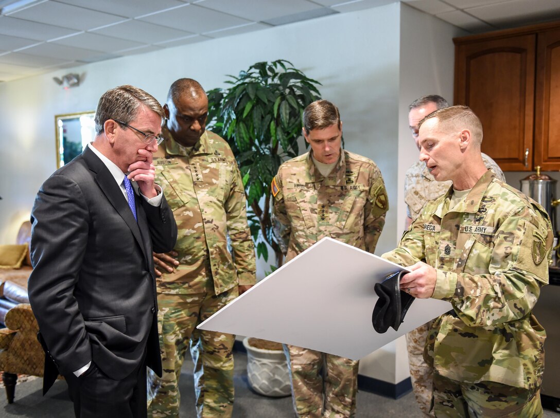 From left to right: Defense Secretary Ash Carter; Army Gen. Lloyd J. Austin III, outgoing commander of U.S. Central Command; Army Gen. Joseph L. Votel, incoming commander; and Marine Corps Gen. Joe. Dunford, chairman of the Joint Chiefs of Staff, receive a briefing before the Centcom change-of-command ceremony at MacDill Air Force Base, Fla., March 30, 2016. DoD photo by Army Sgt. 1st Class Clydell Kinchen