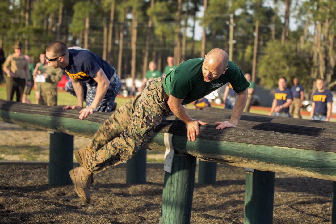 Marines and sailors negotiate a high hurdle during the Commanding General’s Fitness Cup challenge at Parris Island, S.C., March 25, 2016. The event, which aims to promote a lifelong commitment to fitness, included an obstacle course, endurance run, combat fitness test and overall team challenge. Marine Corps photo by Sgt. Jennifer Schubert