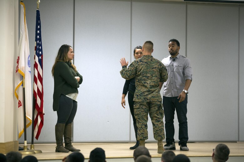 MARINE CORPS BASE CAMP LEJEUNE, N.C. — A Marine interacts with actors with Pure Praxis, a performance troupe, at Camp Johnson, Marine Corps Base Camp Lejeune Jan. 28. Marines were brought on stage to practice providing support and friendship to a victim of sexual assault. 