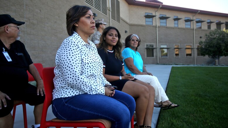 Jennifer Barela, one of Chief Petty Officer Jaclyn Place’s neighbors and the survivors of the brutal attack, looks out at dozens of Marines during Place’s award ceremony at Marine Corps Base Camp Pendleton, California, March 11, 2016. Place, a lead chief petty officer with the Headquarters Regimental Aid Station, 1st Marine Logistics Group, was awarded an impact Navy and Marine Corps Commendation Medal for her selfless and decisive actions that saved the lives of Barela and her daughter. 