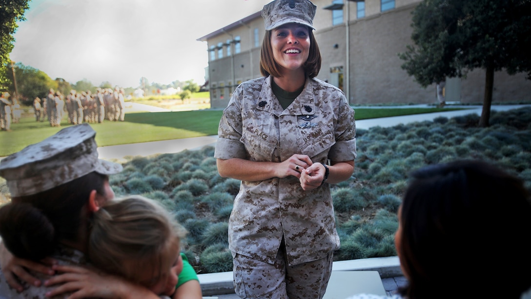 Chief Petty Officer Jaclyn Place laughs at a joke while she waits for her award ceremony to begin at Marine Corps Base Camp Pendleton, California, March 11, 2016. Place is a lead chief petty officer with the Headquarters Regimental Aid Station, 1st Marine Logistics Group, and was awarded an Impact Navy and Marine Corps Commendation Medal for her selfless and decisive actions that saved the lives of her neighbors.