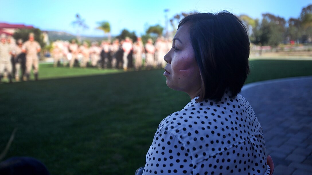 Jennifer Barela, one of Chief Petty Officer Jaclyn Place’s neighbors and the survivors of the brutal attack, looks out at dozens of Marines during Place’s award ceremony at Marine Corps Base Camp Pendleton, California, March 11, 2016. Place, a lead chief petty officer with the Headquarters Regimental Aid Station, 1st Marine Logistics Group, was awarded an impact Navy and Marine Corps Commendation Medal for her selfless and decisive actions that saved the lives of Barela and her daughter.