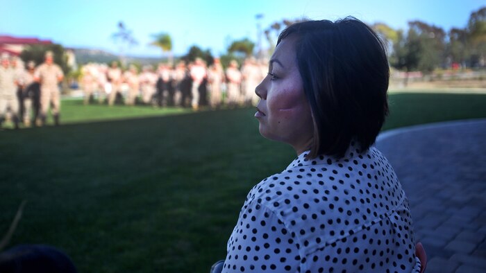 Jennifer Barela, one of Chief Petty Officer Jaclyn Place’s neighbors and the survivors of the brutal attack, looks out at dozens of Marines during Place’s award ceremony at Marine Corps Base Camp Pendleton, California, March 11, 2016. Place, a lead chief petty officer with the Headquarters Regimental Aid Station, 1st Marine Logistics Group, was awarded an impact Navy and Marine Corps Commendation Medal for her selfless and decisive actions that saved the lives of Barela and her daughter.