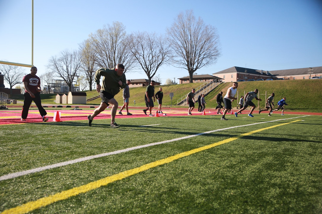 Marines with Marine Corps Recruiting Command participate in a High Intensity Tactical Training (HITT) workout at Butler Stadium aboard Marine Corps Base Quantico, March 30, 2016. The physical training session was a fun way for the Marines to not only exercise, but also build camaraderie within the command. 