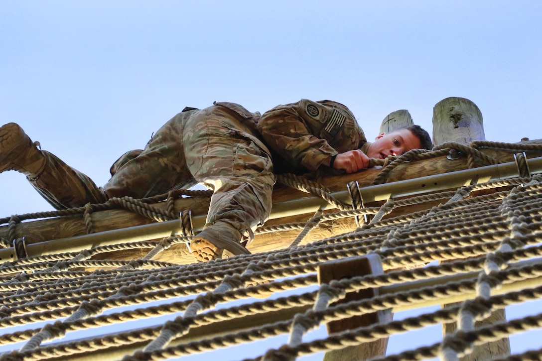 A paratrooper climbs a rope obstacle during physical fitness training at Fort Bragg, N.C., March 24, 2016. Army photo by Sgt. Anthony Hewitt