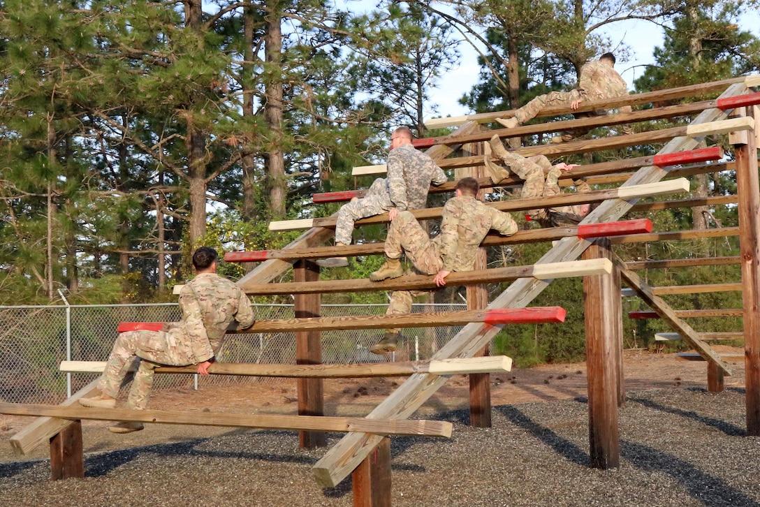 Paratroopers negotiate the weaver obstacle during physical fitness training at Fort Bragg, N.C., March 24, 2016. Army photo by Sgt. Anthony Hewitt