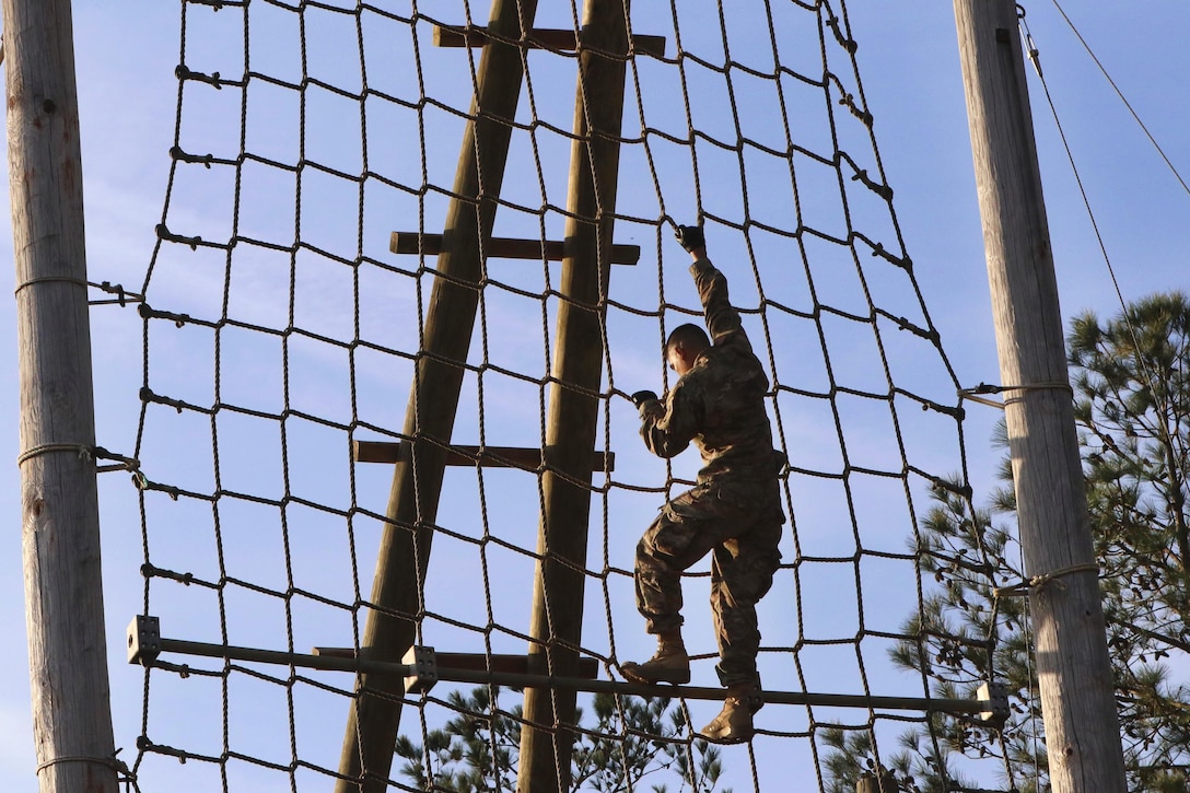 A paratrooper negotiates a rope ladder obstacle during physical fitness training at Fort Bragg, N.C., March 24, 2016. Army photo by Sgt. Anthony Hewitt