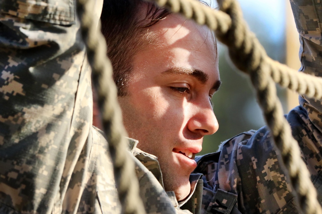 A paratrooper climbs a rope ladder obstacle during physical fitness training at Fort Bragg, N.C., March 24, 2016. Army photo by Sgt. Anthony Hewitt
