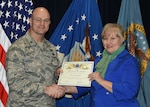 Defense Logistics Agency Aviation Commander Air Force Brig. Gen. Allan Day presents the February Employee of the Month Award to Dawn Hampton during a ceremony March 28, 2016, at Defense Supply Center Richmond, Virginia. Hampton is a price analyst for DLA Aviation’s Procurement Process Support Directorate’s Pricing Division. 