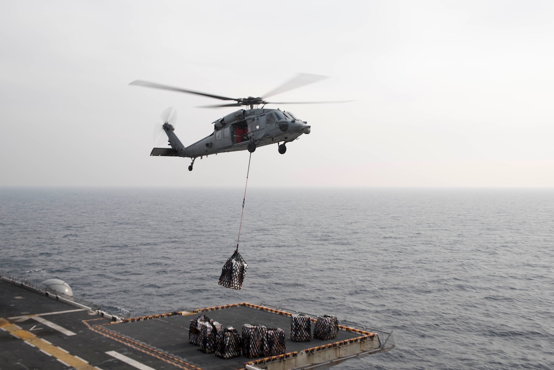 A MH-60S Sea Hawk helicopter, assigned to Helicopter Sea Combat Squadron 25, drops off cargo during a vertical replenishment on the flight deck of amphibious assault ship USS Bonhomme Richard in the East Sea, March 16, 2016. The Bonhomme Richard is the flagship of the Bonhomme Richard Expeditionary Strike Group and is participating in Exercise Ssang Yong 2016. Navy photo by Petty Officer 3rd Class Cameron McCulloch