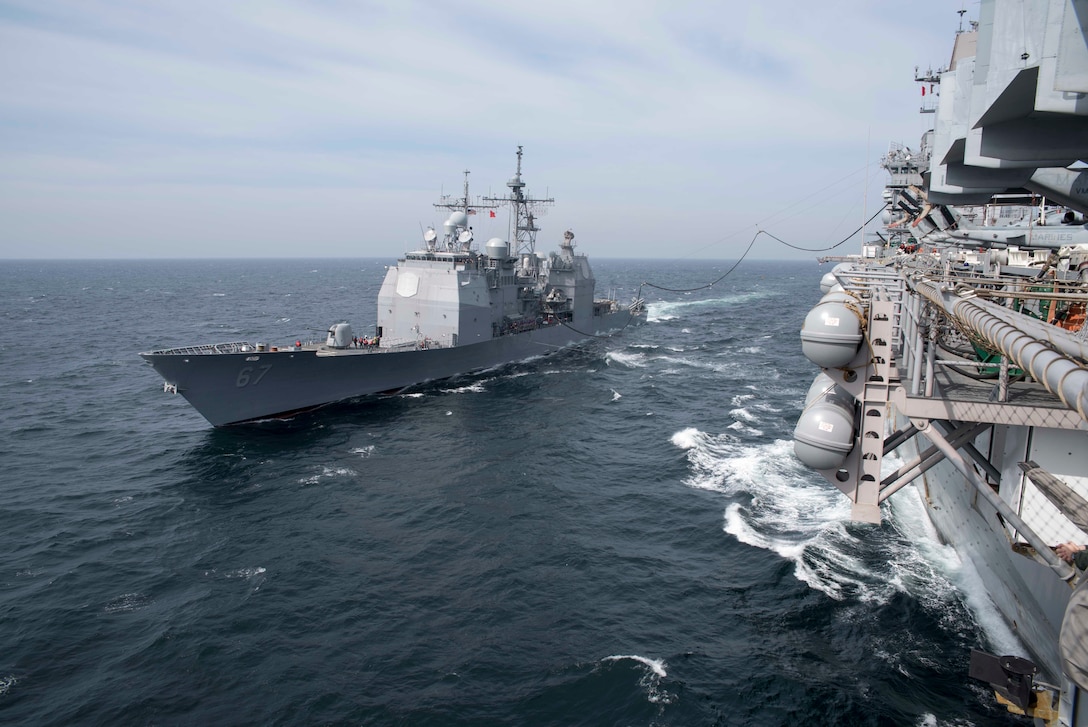 The amphibious assault ship USS Bonhomme Richard, right, and guided-missile cruiser USS Shiloh perform fueling operations during a replenishment at sea in the East Sea, March 16, 2016. Navy photo by Petty Officer 3rd Class Cameron McCulloch 