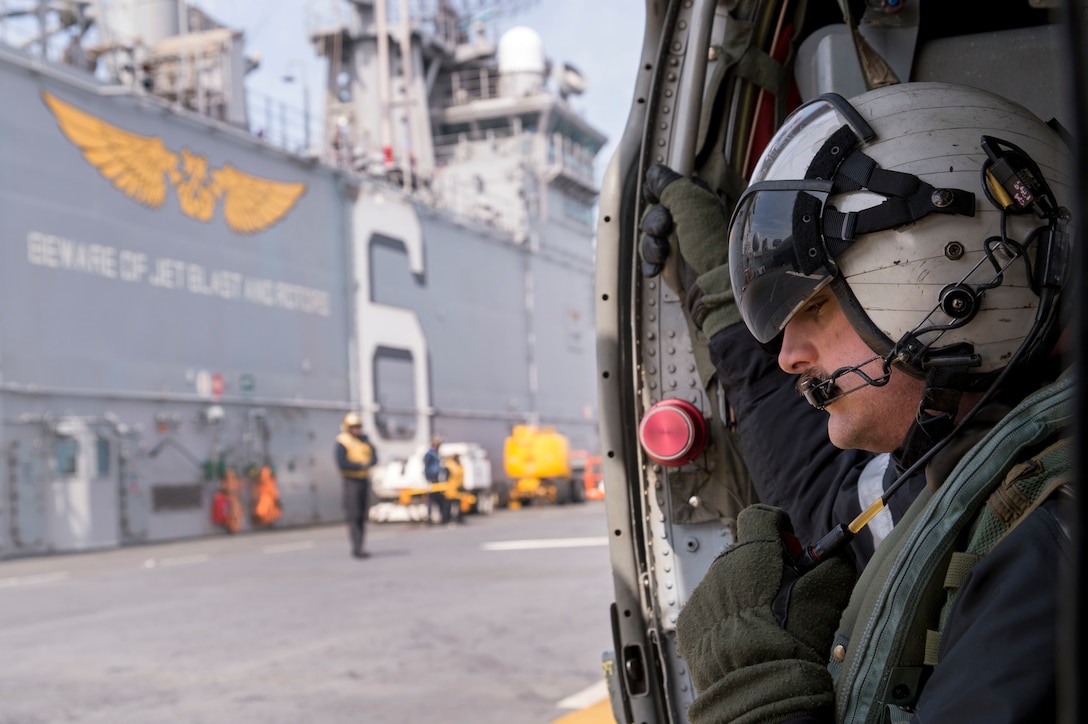 Navy Petty Officer 1st Class Jonathan Hampton prepares to fly in a MH-60S Sea Hawk helicopter aboard the amphibious assault ship USS Bonhomme Richard in the East Sea, March 16, 2016. Hampton is an aircrewman assigned to Helicopter Sea Combat Squadron 25. Navy photo by Petty Officer 3rd Class Jeanette Mullinax