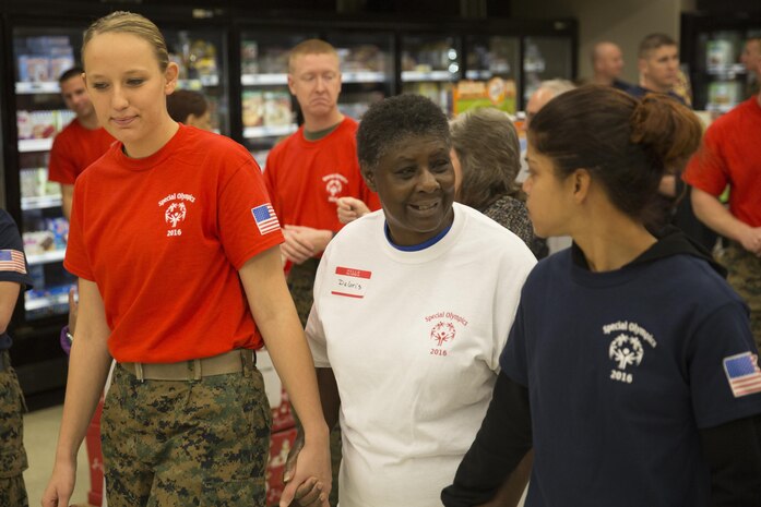 MARINE CORPS AIR STATION NEW RIVER, N.C. — Deloris Cox, a Special Olympics athlete, and her two Marine partners travel to an event during the games hosted by the Marine Corps Air Station New River commissary Jan. 6. Each athlete was allowed to choose two Marines to participate in the games with them.