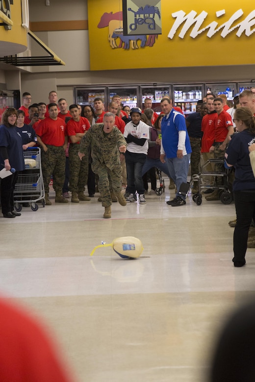 MARINE CORPS AIR STATION NEW RIVER, N.C. — Col. Tim Salmon, commanding officer Marine Corps Air Station New River, opens the Special Olympics event with the first turkey bowl at the commissary Jan. 6. Salmon and the air station Marines hosted Special Olympics athletes from around the area to cheer them on during the competition. 