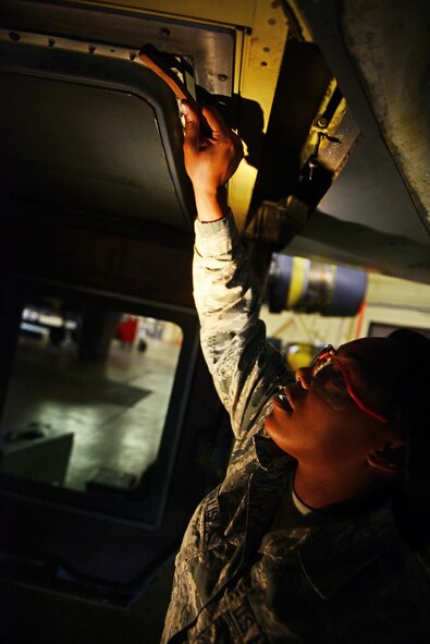 Airman 1st Class Raven Hollis, 2nd Maintenance Squadron communication and navigation systems apprentice, scrubs off rust and build-up on a B-52 Stratofortress during it’s phase inspection at Barksdale Air Force Base, La., March 29, 2016. The B-52 is inspected from top to bottom and repaired as needed during its routine phase inspection. (U.S. Air Force photo/Airman 1st Class Luke Hill) 