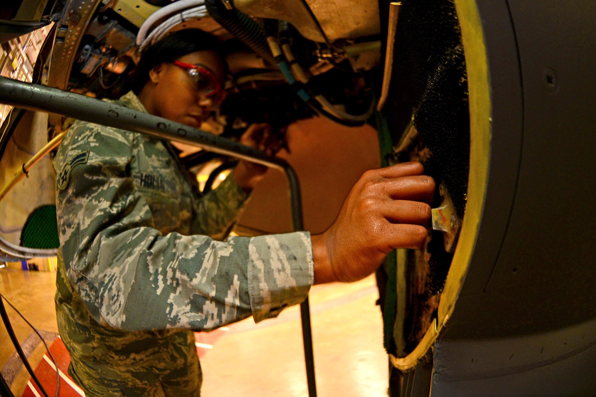 Airman 1st Class Raven Hollis, 2nd Maintenance Squadron communication and navigation systems apprentice, replaces radiation-blocking material on a B-52 Stratofortress at Barksdale Air Force Base, La., March 29, 2016. The radar antenna on a B-52 emits radiation that can be damaging to the human body. This material has to be routinely replaced to ensure that pilots are not exposed to dangerous amounts of radiation. (U.S. Air Force photo/Airman 1st Class Luke Hill) 