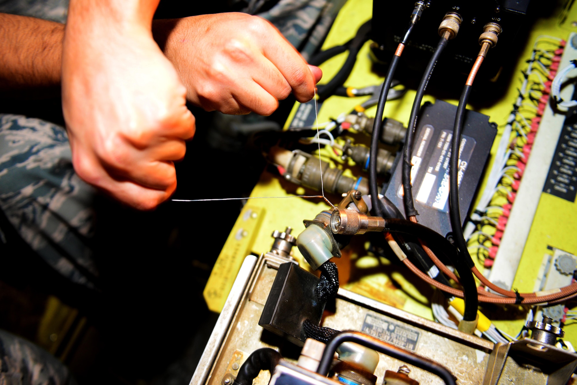 Airman 1st Class Mark Clemente, 2nd Maintenance Squadron communication and navigation systems apprentice, repairs a radio transmitter on a B-52 Stratofortress at Barksdale Air Force Base, La., March 29, 2016. By making repairs to parts that would otherwise need to be replaced, communication and navigation Airmen save the Air Force thousands of dollars. (U.S. Air Force photo/Airman 1st Class Luke Hill)
