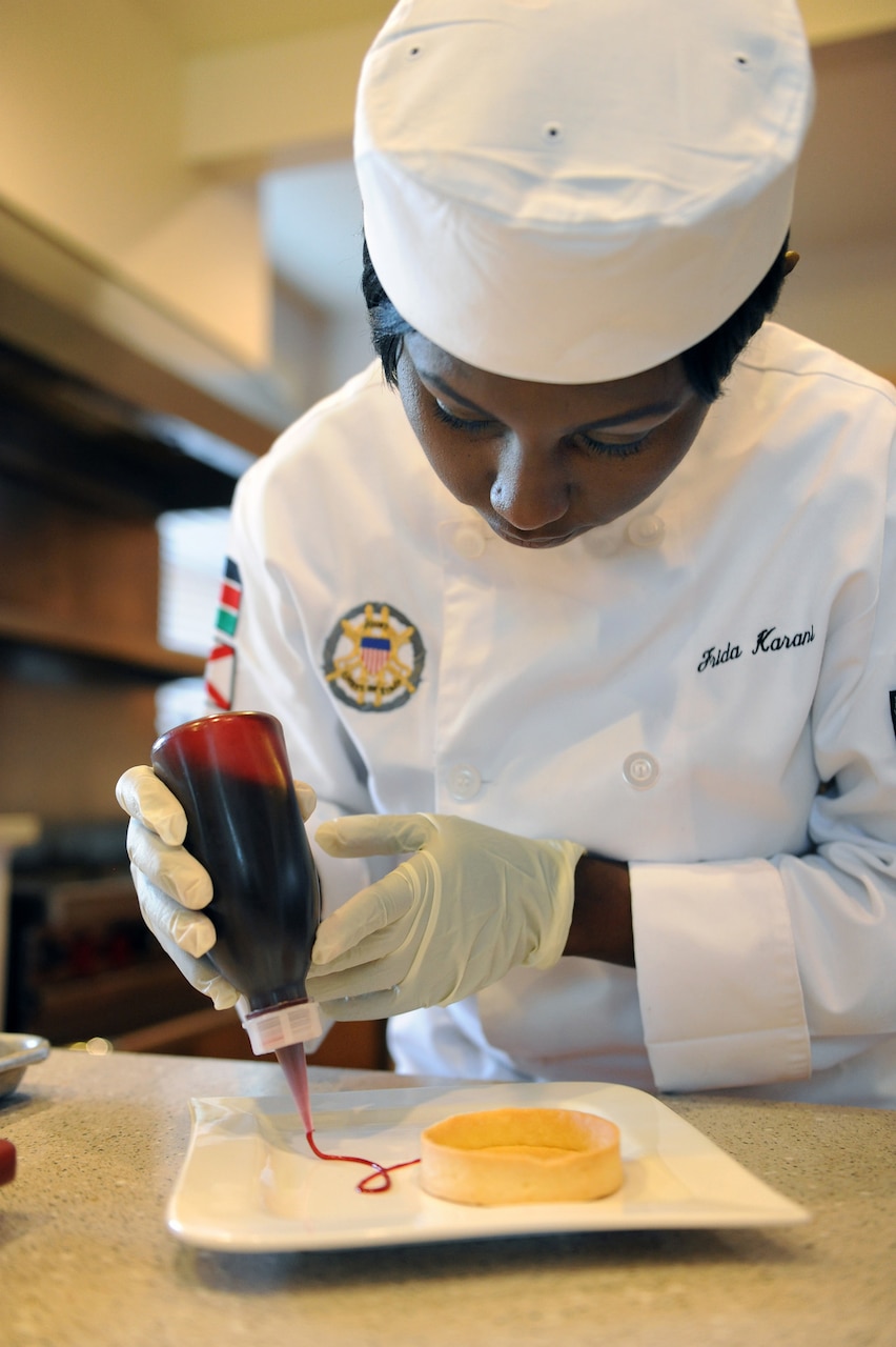 Navy Petty Officer 1st Class Frida Karani, 2016 Armed Forces Chef of the Year and personal chef for the vice chairman of the Joint Chiefs of Staff, works on her culinary presentation techniques as she creates a lemon meringue tart dessert at the vice chairman’s Fort Myer, Virginia, residence, March 24, 2016. DoD photo by Marvin Lynchard