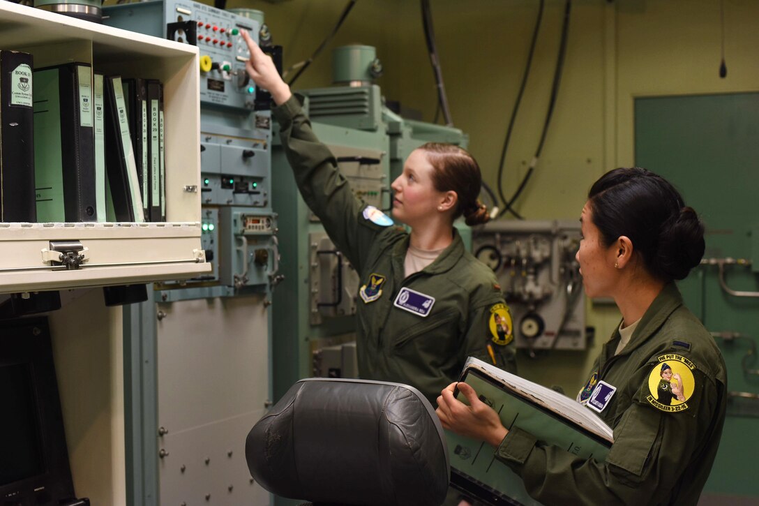 Air Force 2nd Lt. Alexandra Rea, left, and 1st Lt. Elizabeth Guidara participate in training at Malmstrom Air Force Base, Mont., March, 21, 2016. Rea, a combat crew deputy director assigned to the 490th Missile Squadron, and Guidara, a combat crew deputy director assigned to the 12th Missile Squadron, maintain a 24-hour alert shift to sustain an active alert status of the nation’s intercontinental ballistic missile force. Air Force photo by Airman Collin Schmidt