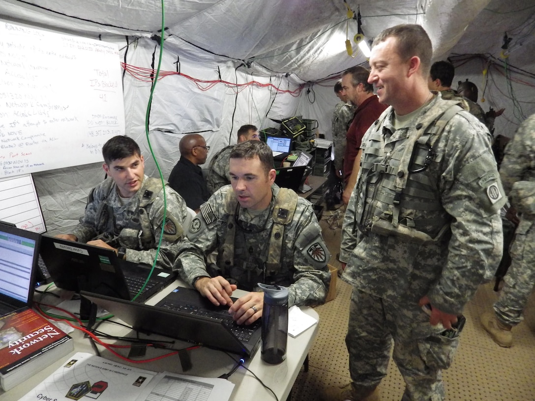 Army Sgts. 1st Class Richard Miller, left, and Brian Rowcotsky, center, of the U.S. Army Cyber Protection Brigade discuss the response to a simulated cyberattack on the 1st Brigade Combat Team, 82nd Airborne Division, with Army Staff Sgt. Frederick Roquemore, a cyber network defender with the brigade, at the Joint Readiness Training Center at Fort Polk, La., Nov. 6, 2015. The Defense Department’s innovation outpost in Silicon Valley is hosting an information meeting with Army and Defense Advanced Research Projects Agency officials March 31, 2016, to highlight potential contracting opportunities. Army photo by Bill Roche