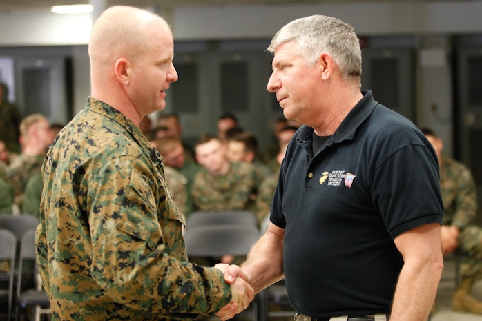 Harrisonburg, Va.-native 1st Sgt. Matthew A. Moore, left, company first sergeant of headquarters and service company, Chemical Biological Incident Response Force (CBIRF), U.S. Marine Corps Forces Command (MARFORCOM), shakes hands with Patrick Higgins, Downey Responder Training Facility lead instructor with CBIRF prior to a CBIRF Basic Operations Course graduation ceremony at Naval Support Facility Indian Head, Md., Mar. 11, 2016. The course is a three-week program that provides approximately 145 hours of classroom, practical applications and individual and team testing in chemical, biological, radiological, nuclear, and high-yield explosive disciplines that meet federal requirements. After graduating the course, each Marine and sailor will be qualified to enter a contaminated area, search the area, provide emergency first aid and provide assistance to nonambulatory patients. Regardless of their jobs, or military occupational specialty, every Marine and sailor with CBIRF is required to complete the course, making the unit uniquely qualified to respond with minimal warning to a chemical, biological, radiological, nuclear or high-yield explosive (CBRNE) threat. (Official USMC Photos by Sgt. Jonathan S. Herrera/Released)
