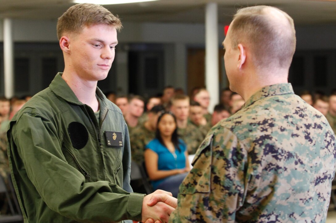 Akron, Ohio-native Pfc. Bradley J. Keen, aircraft rescue and firefighting specialist, left, shakes hands with Col. Steve E. Redifer, commanding officer of the Chemical Biological Incident Response Force (CBIRF), U.S. Marine Corps Force Command (MARFORCOM), during a CBIRF Basic Operations Course graduation ceremony at Naval Support Facility Indian Head, Md., Mar. 11, 2016. The course is a three-week program that provides approximately 145 hours of classroom, practical applications and individual and team testing in chemical, biological, radiological, nuclear, and high-yield explosive (CBRNE) disciplines that meet federal requirements. After graduating the course, each Marine and sailor will be qualified to enter a contaminated area, search the area, provide emergency first aid and provide assistance to nonambulatory patients. Regardless of their jobs, or military occupational specialty, every Marine and sailor with CBIRF is required to complete the course, making the unit uniquely qualified to respond with minimal warning to a CBRNE threat. (Official USMC Photos by Sgt. Jonathan S. Herrera/Released)
