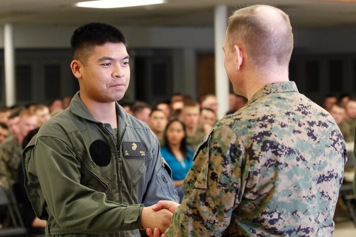 Norfolk, Va.-native Lance Cpl. Jason B. Embile, logistics/embarkation specialist, left, shakes hands with Col. Steve E. Redifer, commanding officer of the Chemical Biological Incident Response Force (CBIRF), U.S. Marine Corps Force Command (MARFORCOM), during a CBIRF Basic Operations Course graduation ceremony at Naval Support Facility Indian Head, Md., Mar. 11, 2016. The course is a three-week program that provides approximately 145 hours of classroom, practical applications and individual and team testing in chemical, biological, radiological, nuclear, and high-yield explosive (CBRNE) disciplines that meet federal requirements. After graduating the course, each Marine and sailor will be qualified to enter a contaminated area, search the area, provide emergency first aid and provide assistance to nonambulatory patients. Regardless of their jobs, or military occupational specialty, every Marine and sailor with CBIRF is required to complete the course, making the unit uniquely qualified to respond with minimal warning to a CBRNE threat. (Official USMC Photos by Sgt. Jonathan S. Herrera/Released)
