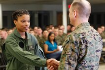 Orangeburg, S.C.-native Cpl. Cierra M. Woods, warehouse clerk, left, shakes hands with Col. Steve E. Redifer, commanding officer of the Chemical Biological Incident Response Force (CBIRF), U.S. Marine Corps Force Command (MARFORCOM), during a CBIRF Basic Operations Course graduation ceremony at Naval Support Facility Indian Head, Md., Mar. 11, 2016. The course is a three-week program that provides approximately 145 hours of classroom, practical applications and individual and team testing in chemical, biological, radiological, nuclear, and high-yield explosive (CBRNE) disciplines that meet federal requirements. After graduating the course, each Marine and sailor will be qualified to enter a contaminated area, search the area, provide emergency first aid and provide assistance to nonambulatory patients. Regardless of their jobs, or military occupational specialty, every Marine and sailor with CBIRF is required to complete the course, making the unit uniquely qualified to respond with minimal warning to a CBRNE threat. (Official USMC Photos by Sgt. Jonathan S. Herrera/Released)