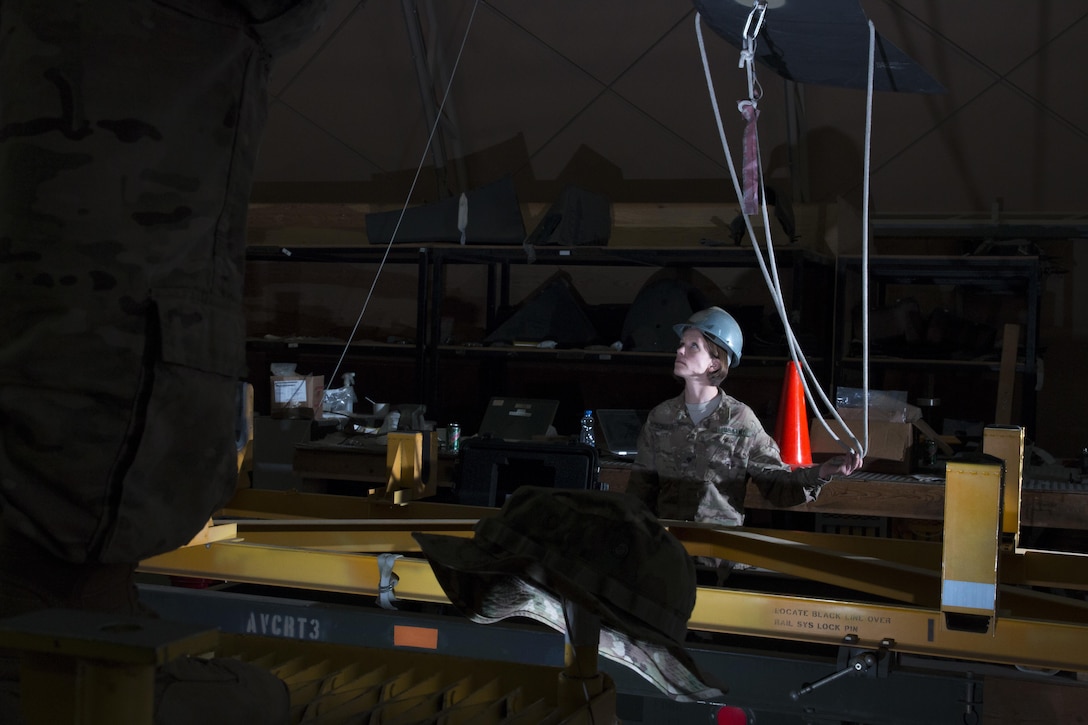 Army Spc. Heidi Schuler assists with reattaching a rotor blade on a UH-60 Black Hawk helicopter at Camp Buehring, Kuwait, March 24, 2016. Schuler is a helicopter repairman assigned to the California Army National Guard’s Company B, 640th Aviation Support Battalion, 40th Combat Aviation Brigade. Army photo by Staff Sgt. Ian M. Kummer