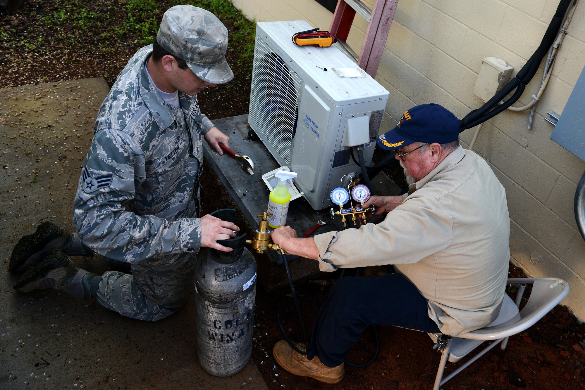 U.S. Air Force Senior Airman Darek Vetter and Louis Lorick, 20th Civil Engineer Squadron heating, ventilation, and air conditioning technicians, use a regulator to measure the gas pressure of a heating and air conditioning condenser at the 20th Equipment Maintenance Squadron March 28, 2016, at Shaw Air Force Base, S.C. The HVAC shop is in charge of more than one thousand units across Shaw, Poinsett Electronic Combat Range, and Wateree Recreational Area. (U.S. Air Force photo by Airman 1st Class Destinee Dougherty)