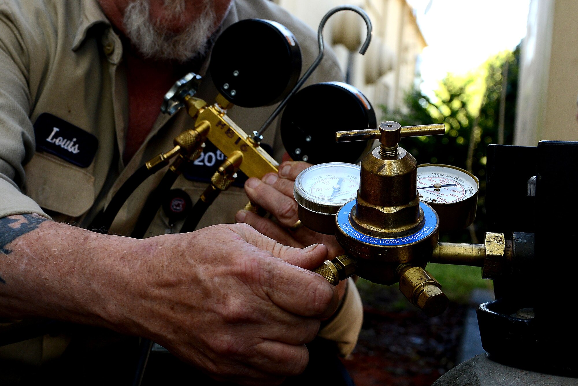 Louis Lorick, 20th Civil Engineer Squadron heating, ventilation, and air conditioning technician, checks the gas pressure of a heating and air conditioning condenser at Shaw Air Force Base, S.C., March 28 2016. After introducing nitrogen to the system, Lorick was able to determine if there was a leak by measuring the amount of pressure the system gave off. The HVAC shop maintains units for more than 300 buildings. (U.S. Air Force photo by Airman 1st Class Destinee Dougherty)