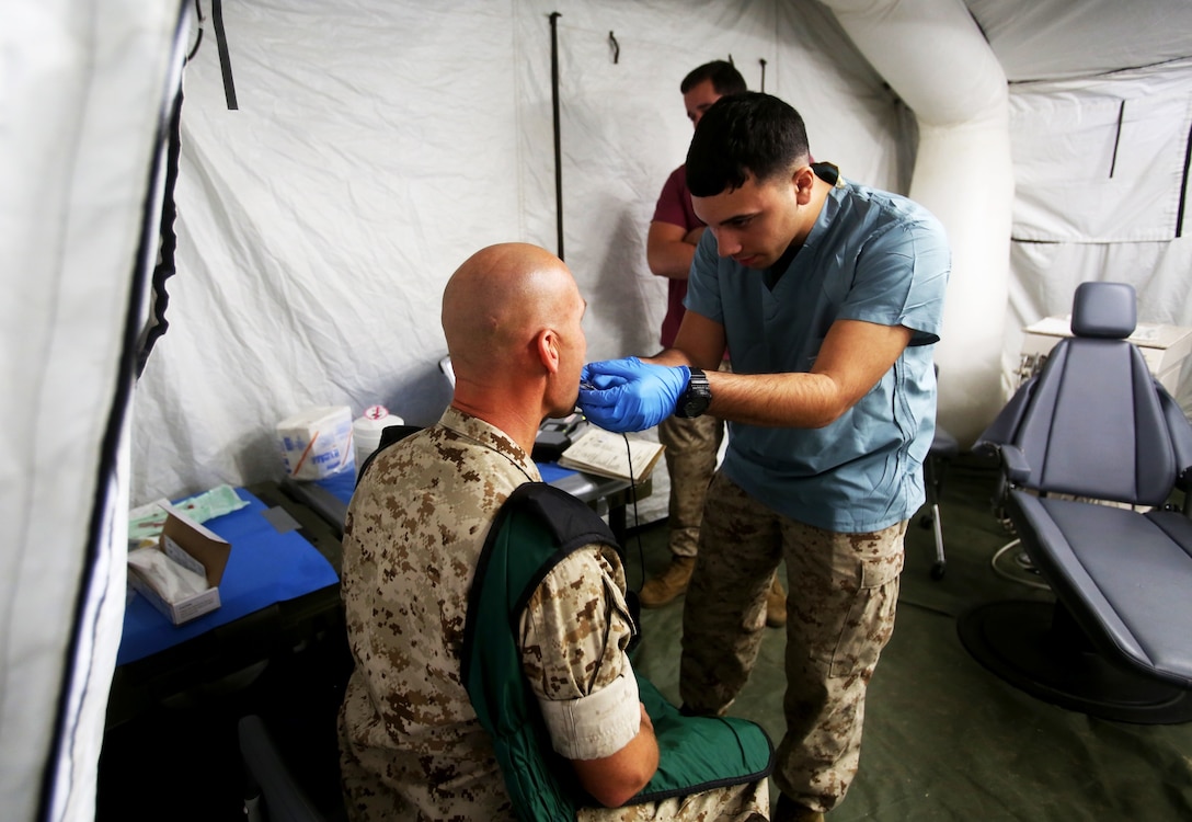 Seaman Nicholas Burns prepares a patient for a dental x-ray during Authorized Dental Allowance List Exercise aboard Camp Pendleton, Calif., March 13-25, 2016. Burns is a corpsman with 1st Dental Battalion, 1st Marine Logistics Group. ADALEX, which is being conducted for the first time in 10 years, is intended to increase the unit’s expeditionary dental capabilities by operating in a field environment. (U.S. Marine Corps photo by Cpl. Carson Gramley/released)