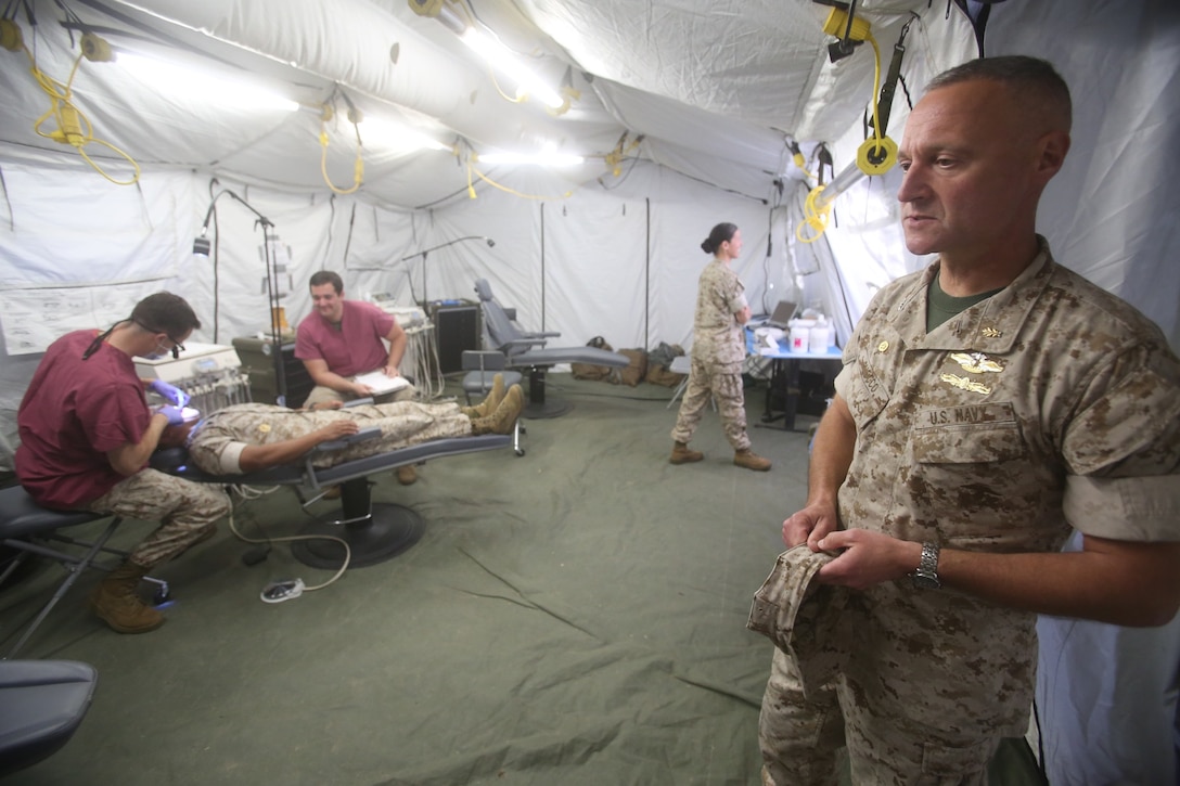 Captain Peter Ruocco observes the patients being treated during Authorized Dental Allowance List Exercise aboard Camp Pendleton, Calif., March 13-25, 2016. Ruocco is the commanding officer of 1st Dental Battalion, 1st Marine Logistics Group. ADALEX, which is being conducted for the first time in 10 years, is intended to increase the unit’s expeditionary dental capabilities by operating in a field environment.  (U.S. Marine Corps photo by Cpl. Carson Gramley/released)