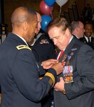 Vietnam War veterans are cheered on by volunteers as they parade down a red-carpet into a Vietnam War Commemoration program March 29, 2016 at the Pennsylvania National Guard Armory in Philadelphia, PA. More than 400 Vietnam War era veterans attended the event sponsored by the Association of the United States Army and Vietnam War Commemoration partners Defense Logistics Agency Troop Support and the Corporal Michael J. Crescenz Veterans Affairs Medical Center.