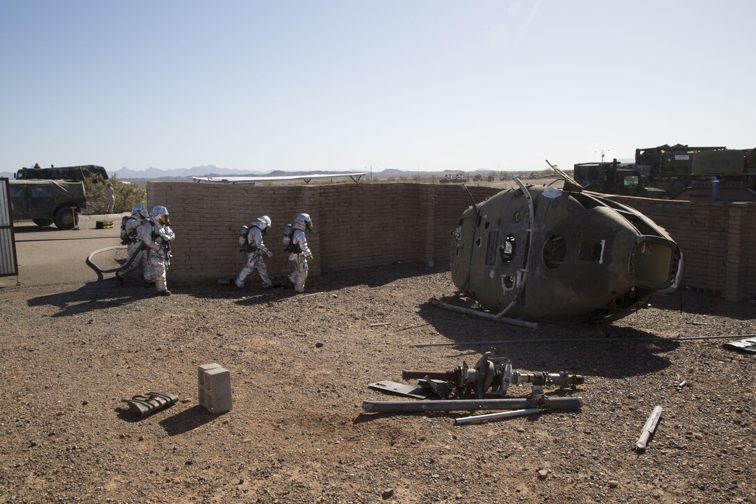 Marines sweep an aircraft for a potential fire during an aircraft salvage exercise as part of a Weapons and Tactics Instructor course at K-9 Village, Yuma Proving Grounds, Yuma, Ariz., March 30, 2016. The Marines are assigned to Crash Fire Rescue, Marine Wing Support Squadron 274. Marine Corps photo by Lance Cpl. Anabel Abreu-Rodriguez 
