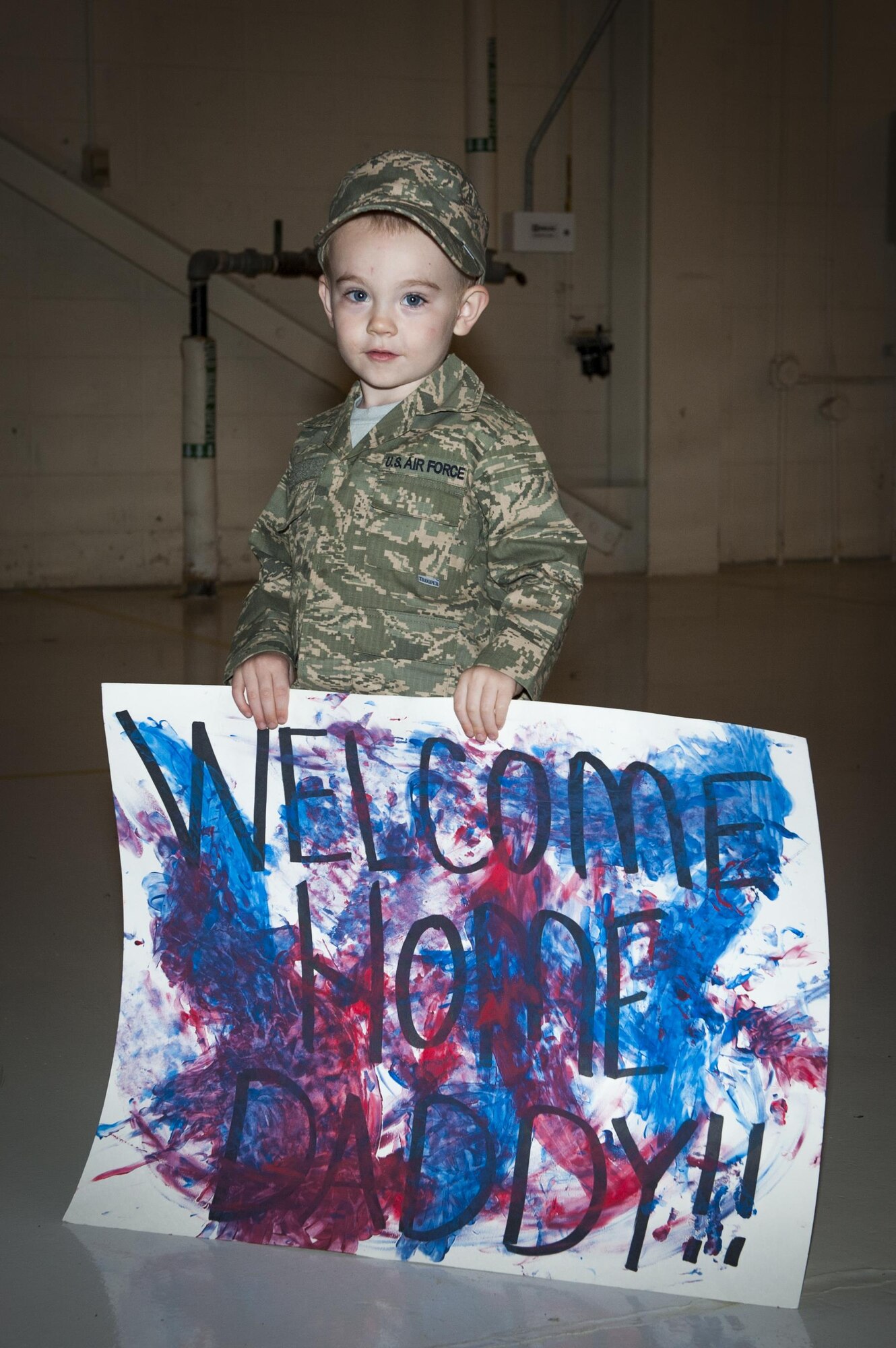 Wade Thompson, son of U.S. Air Force Staff Sgt. Joseph Thompson, 74th Expeditionary Fighter Squadron lead crew member, stands with a welcome home sign during a redeployment, March 30, 2016, at Moody Air Force Base, Ga. The 74th EFS returned from a theater security package deployment throughout Eastern Europe. (U.S. Air Force photo by Airman 1st Class Lauren M. Hunter/Released)